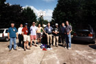 9 of the 12 1999 Tourists pose for yet another team picture in the car park at the back of the hotel at Le Grand Luc.
